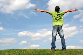 picture of man standing in field with arms streatched out...symbol of recovery