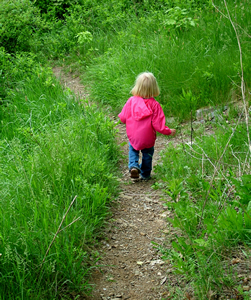 Girl on a gravel path in a field