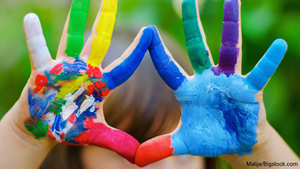 a pair of children's hands with paint all over them
